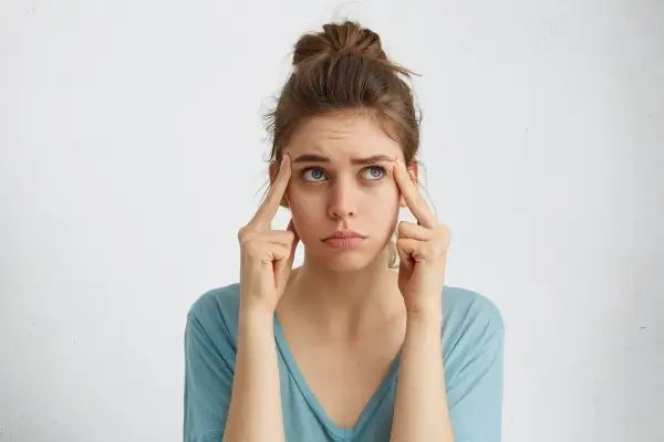 a confused woman having fine lines on forehead