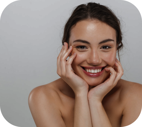 a smiling woman posing with hands on her cheeks front view