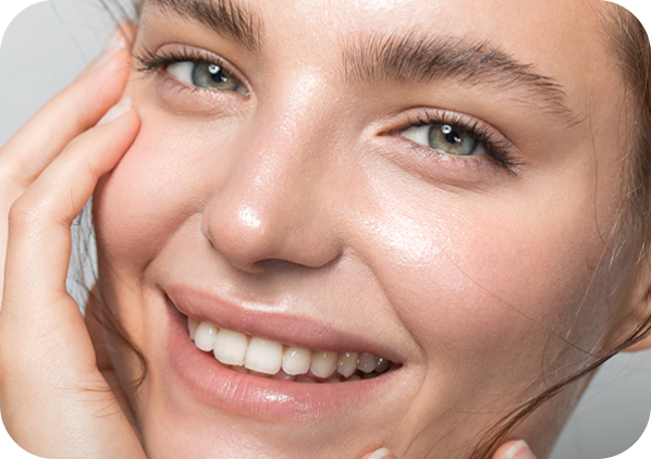 a smiling woman with smooth skin after a dermal filler treatment at the laser cafe