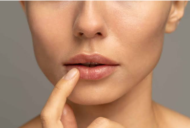 lips showing a flat cupid's bow shape, with a finger gently touching the bottom