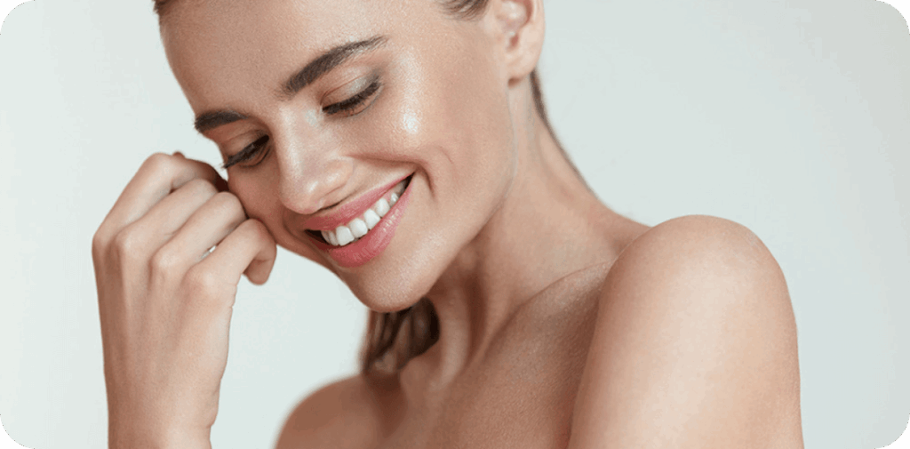 a women smiling with smooth, enhanced lips after lip filler injection