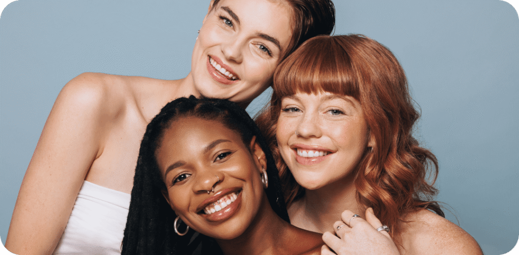 three women's smiling together